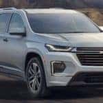 2021 Chevrolet Traverse going down the road will hills in the background