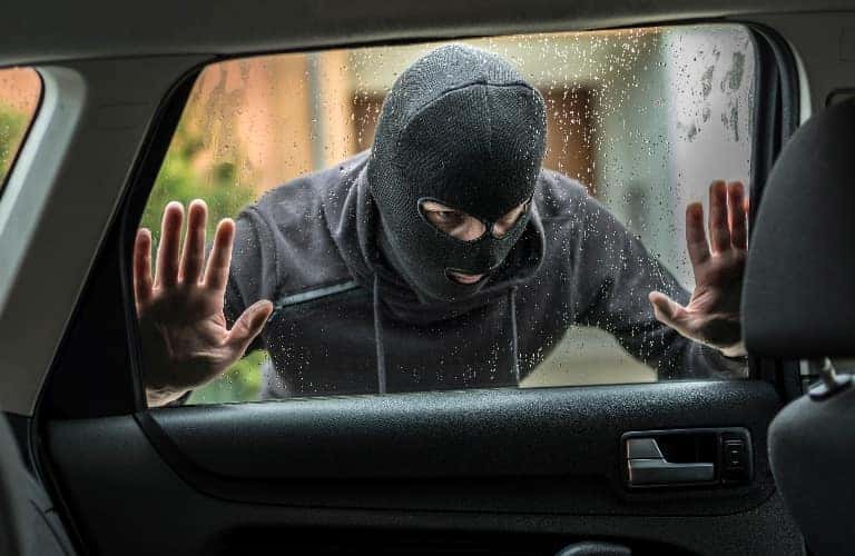 Person looking into the window of a vehicle