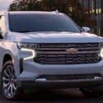 2021 Chevrolet Suburban parked in front of a building with many windows