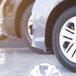 Close up of the tires of three cars lined up