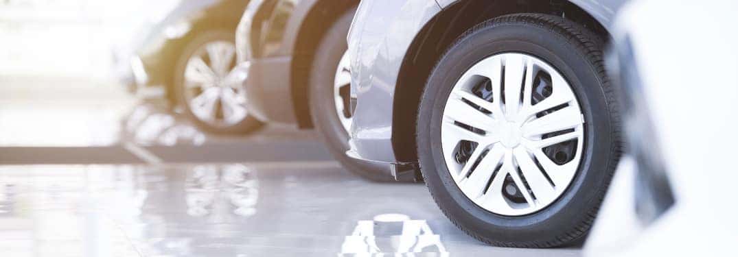 Close up of the tires of three cars lined up