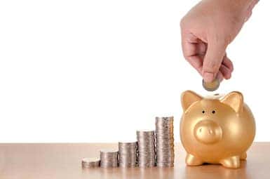 A person saving money in a piggy bank