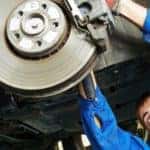 Mechanic working on a vehicle's brake