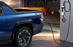2024 Chevrolet Silverado EV plugged in to a wall charger