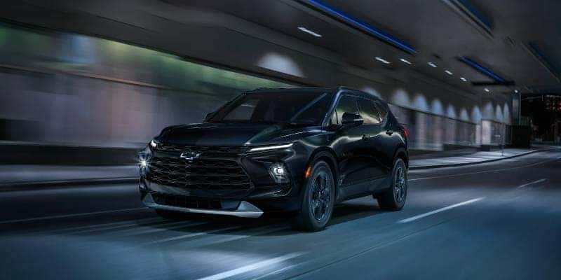 A Chevy Blazer driving along a freeway at night
