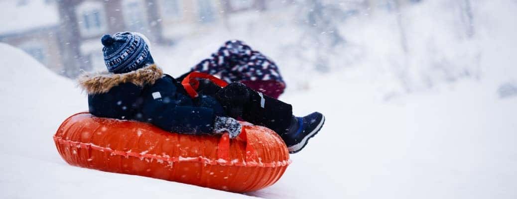 A young girl sledding at some of the best sledding near Kennesaw.