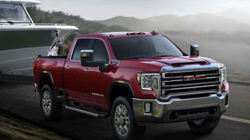 A front view of the 2023 GMC Sierra 1500 towing a boat.