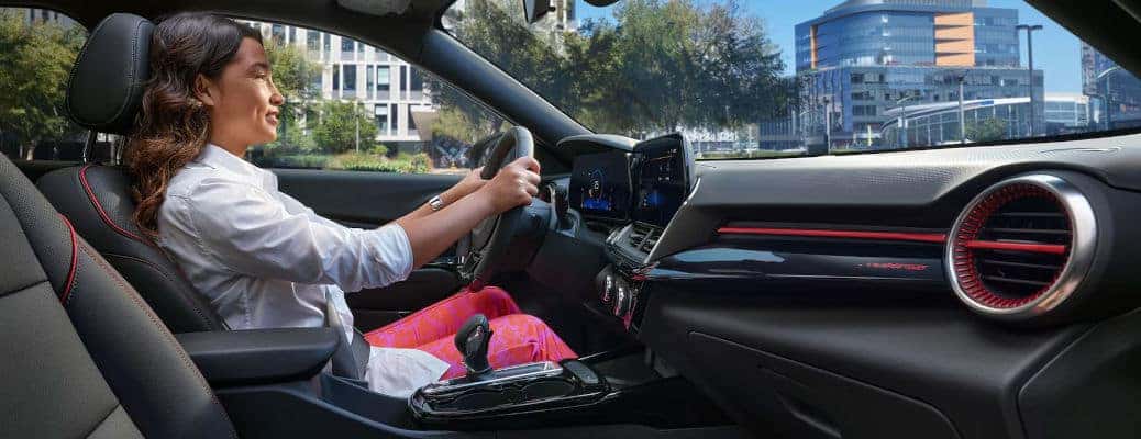 A woman driving the 2024 Chevy Trax while using its advanced safety features.