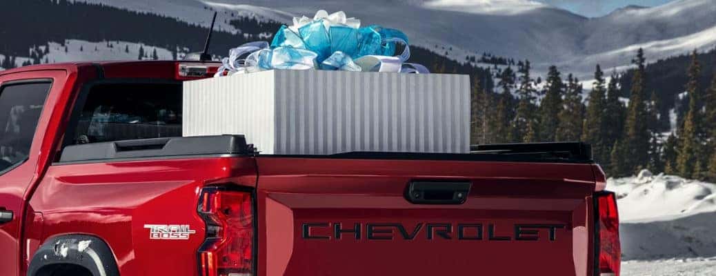 Chevy truck with a giant Christmas gift in the bed.