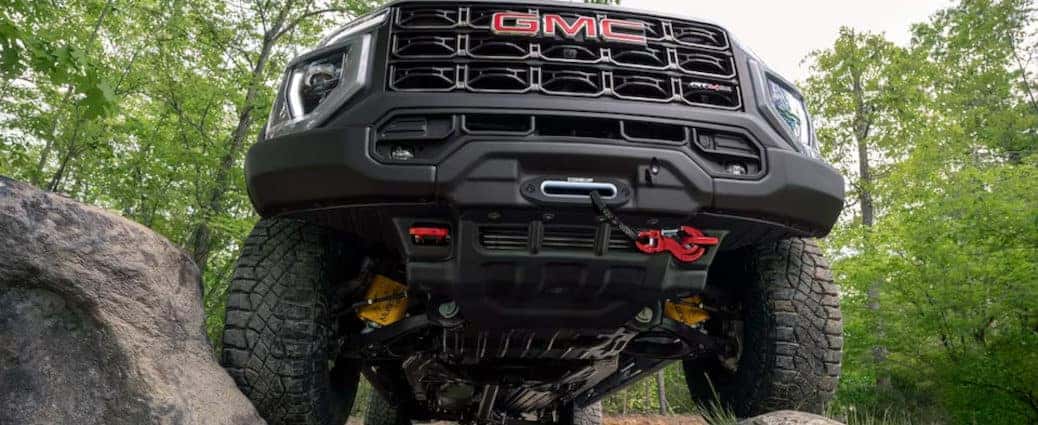 The 2024 GMC Canyon utilizing its rock climbing off-roading features.