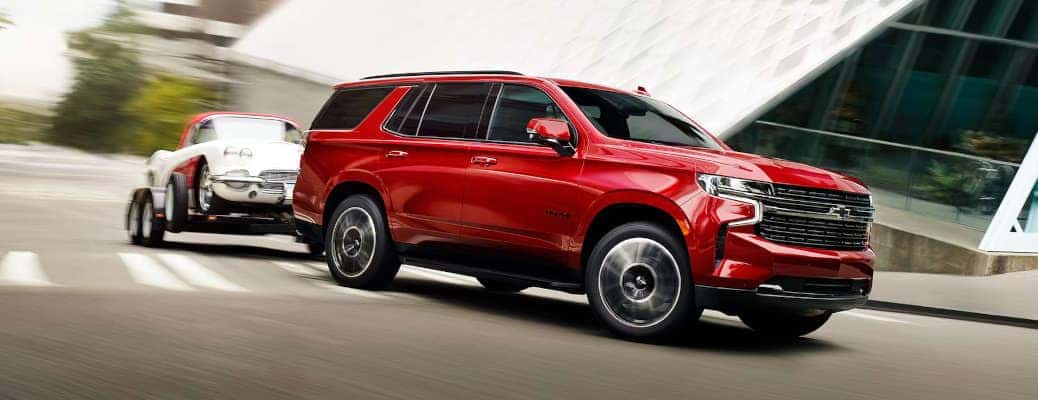 The 2024 Chevy Tahoe towing a car.