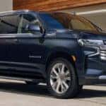 An exterior shot of a family with there 2025 Chevy Suburban equipped with Chevy Safety Assist.