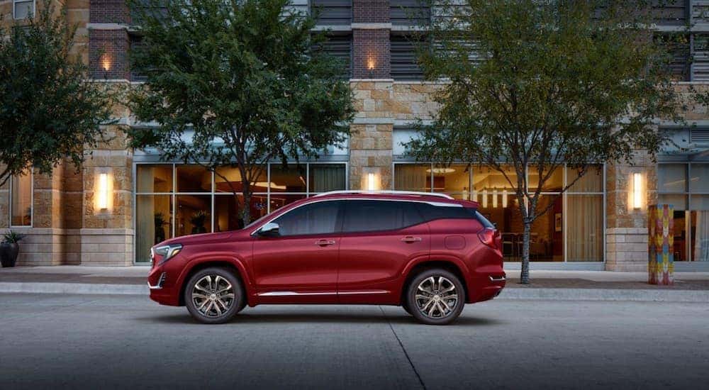 A red 2019 GMC Terrain Denali in front of a stone building