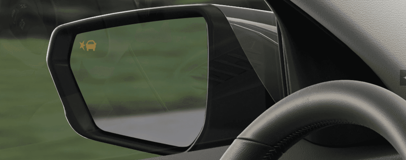 A close up of the mirror of a 2019 GMC Terrain's Lane Change Assist feature.