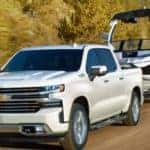 white chevy silverado 1500 towing a boat