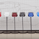 Lineup of 12 color examples in front of Corvette drawing