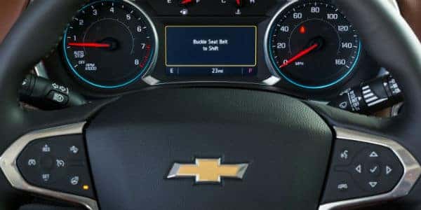 Closeup of Chevrolet vehicle dashboard with "Buckle Seat Belt to Shift" prompt