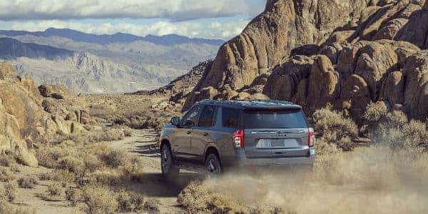 Rear view of 2021 Chevrolet Tahoe driving in desert