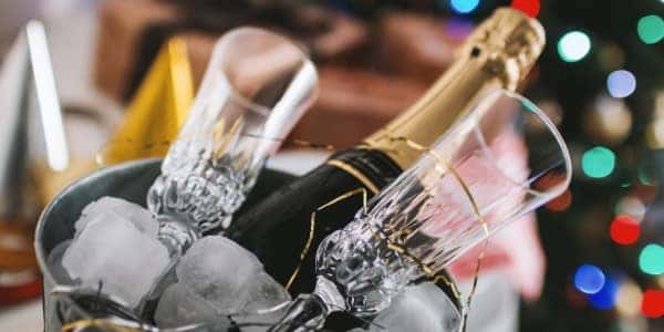 Champagne bottles and glasses in an ice bucket