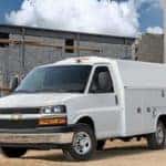 A white 2020 Chevy Express Cutaway parked on a worksite.