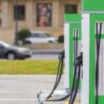 Two green EV charging stations in a parking lot