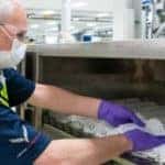 A man in a GM factory makes masks to combat COVID-19