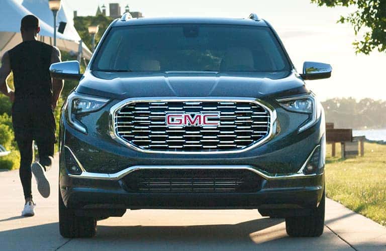 Head-on view of a 2020 GMC Terrain as a man jogs past.