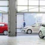 Several 2017 Chevy Spark models surrounding a weird garage