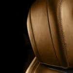 Close-up on a brown leather vehicular headrest.
