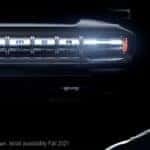 Lebron James' face looms beside the glowing grill of a pre-production 2022 GMC Hummer EV