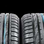 Close-up of four tires in line on black background
