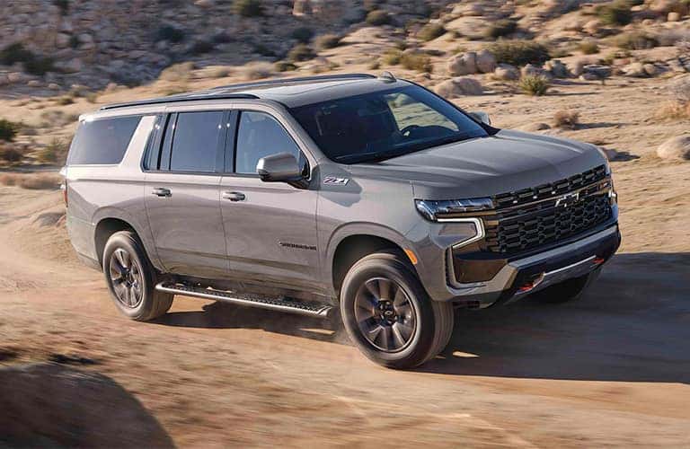 2023 Chevrolet Suburban side view on a dirt path