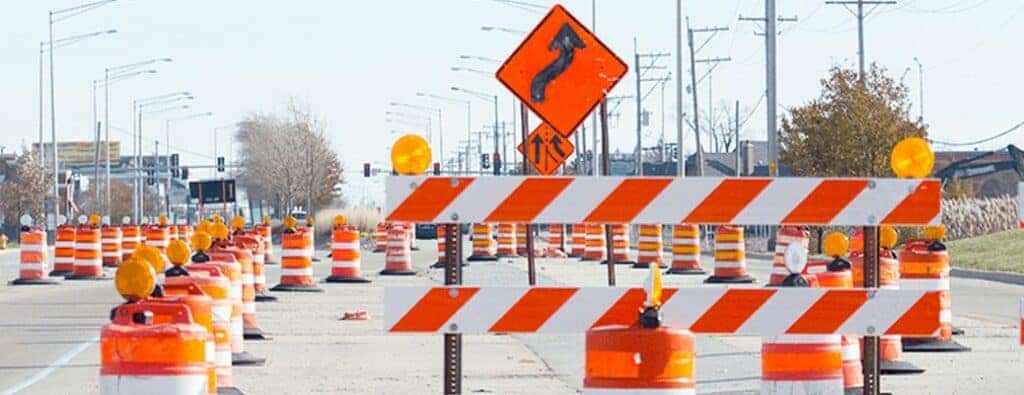 orange and white barrier and cones at a construction site