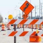 orange and white barrier and cones at a construction site