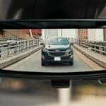 A Chevrolet rear camera mirror showing a vehicle