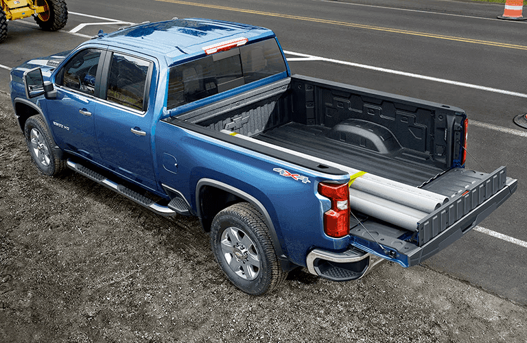 2023 Chevrolet Silverado HD truck with two white poles in its bed