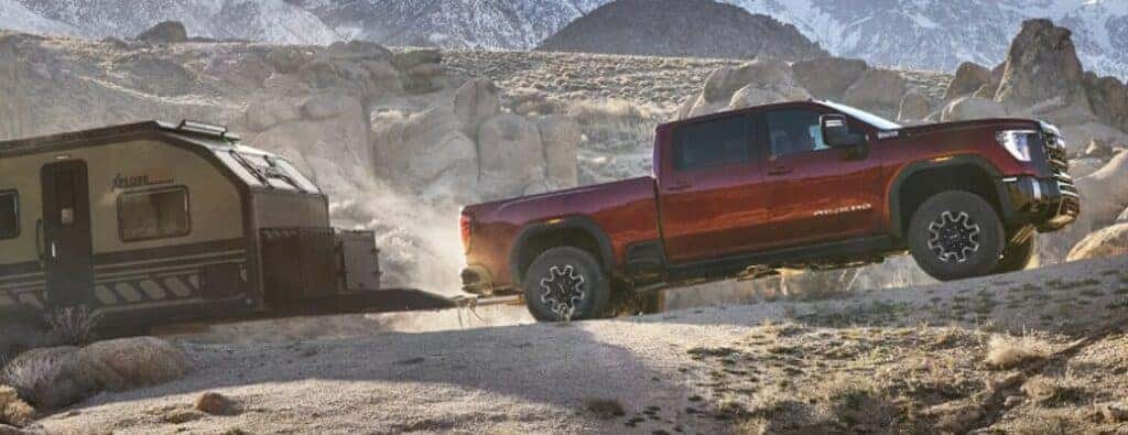 2024 GMC Sierra HD AT4X truck side view towing a trailer