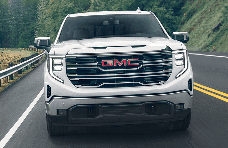 2024 GMC Sierra front view on a road with white paint