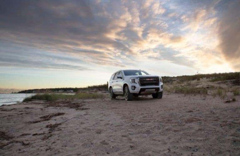 2024 GMC Yukon SUV parked on sand