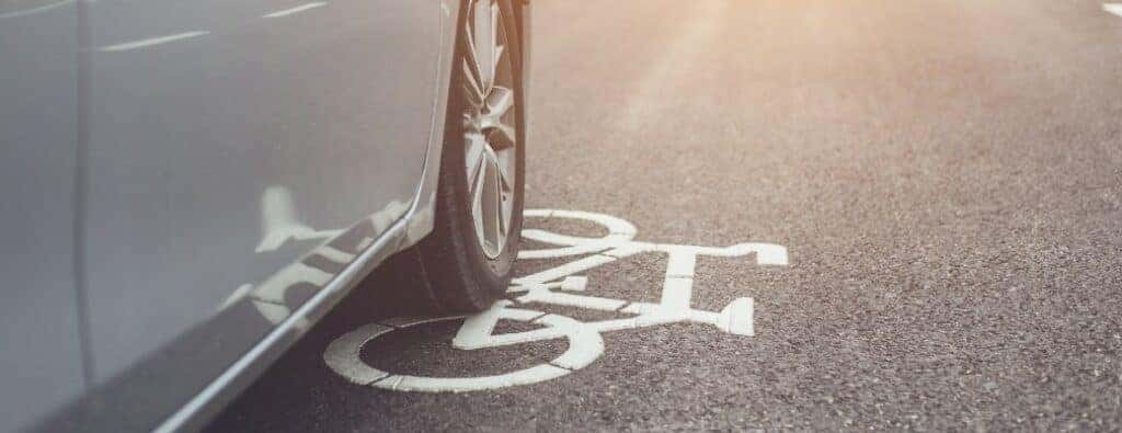 a car driving over the bike lane marker