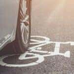 a car driving over the bike lane marker