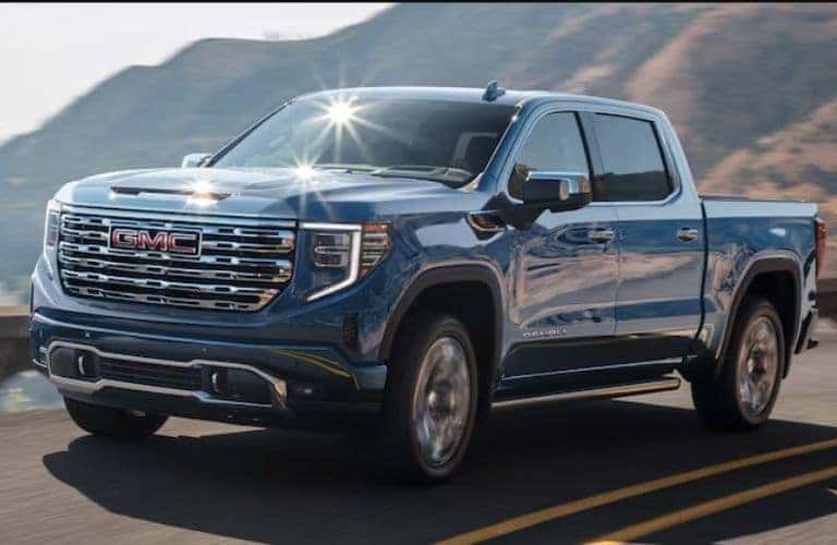 2024 GMC Sierra Denali front and side view on a road