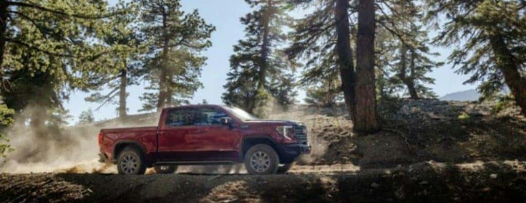 2024 GMC Sierra truck side view in forest