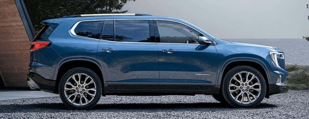 2024 GMC Acadia Denali side view with blue paint