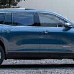 2024 GMC Acadia Denali side view with blue paint
