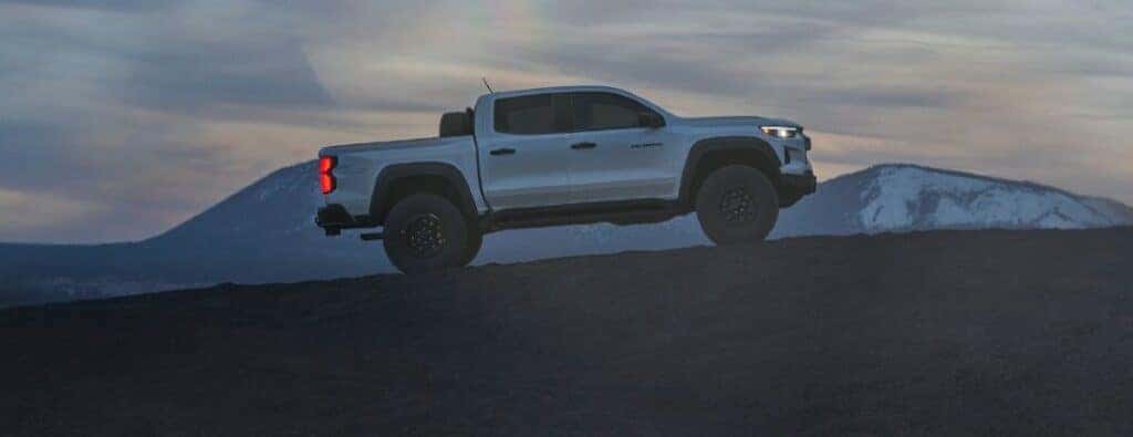 2024 Chevrolet Colorado truck side view on an incline at night