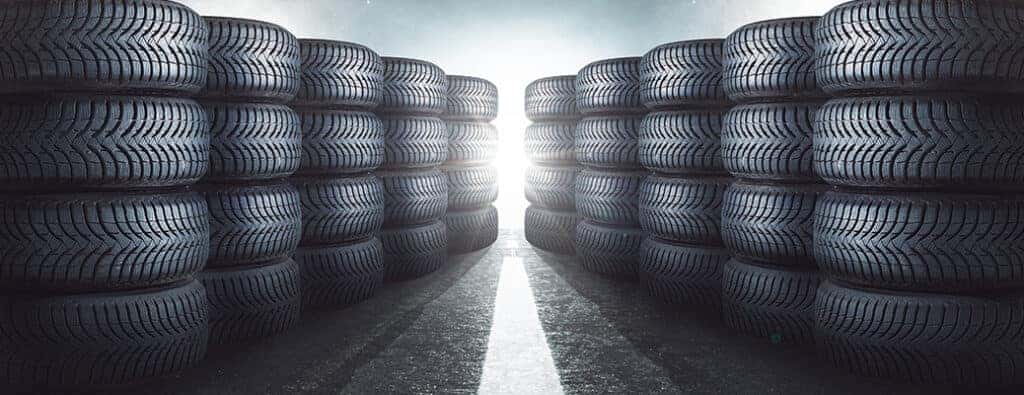 two rows of tires in stacks with light in the middle
