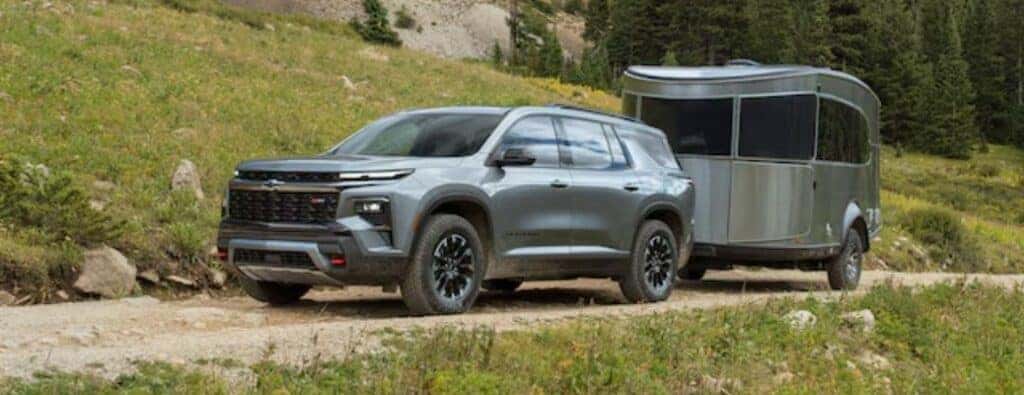 2024 Chevrolet Traverse towing a trailer on a dirt trail