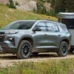 2024 Chevrolet Traverse towing a trailer on a dirt trail