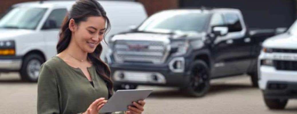 a woman at a dealership using her phone